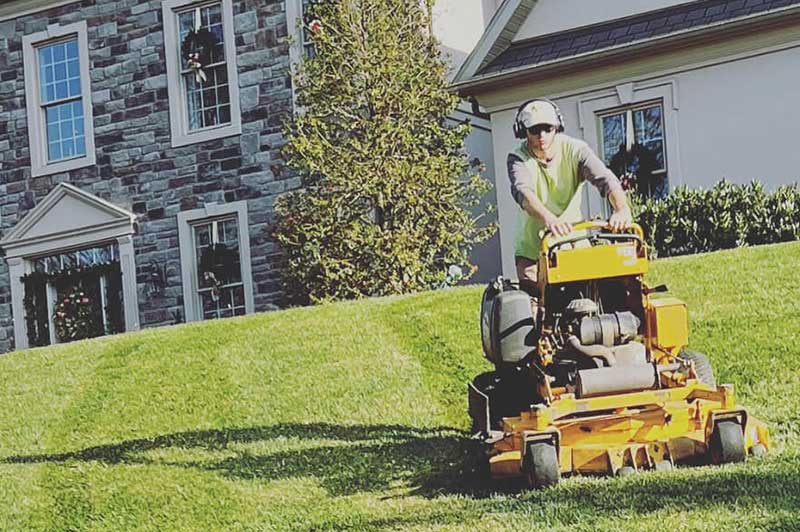 Employee mowing lawn