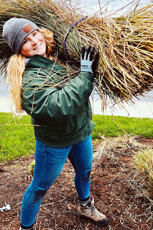 Horticulturist performing Spring cleanup of landscaping